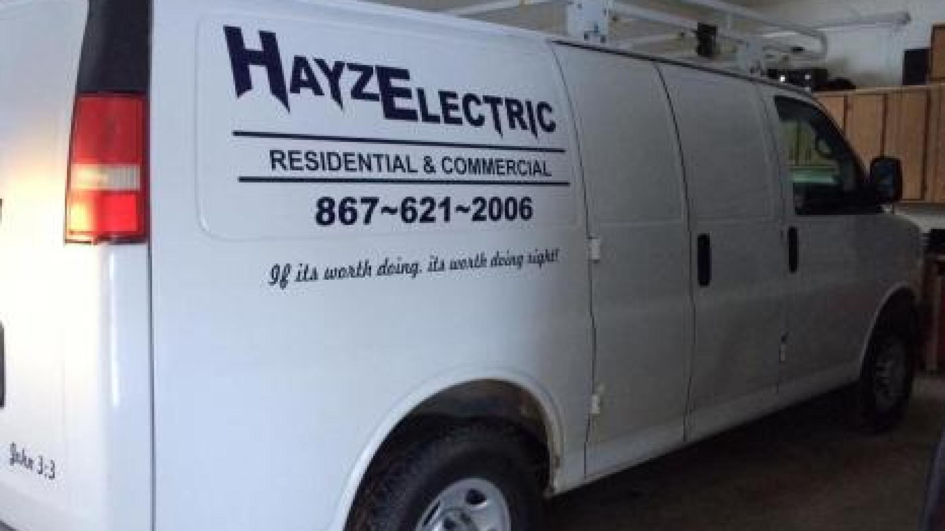 Parked white van with a "Hayze Electric" decal near the rear, right end.