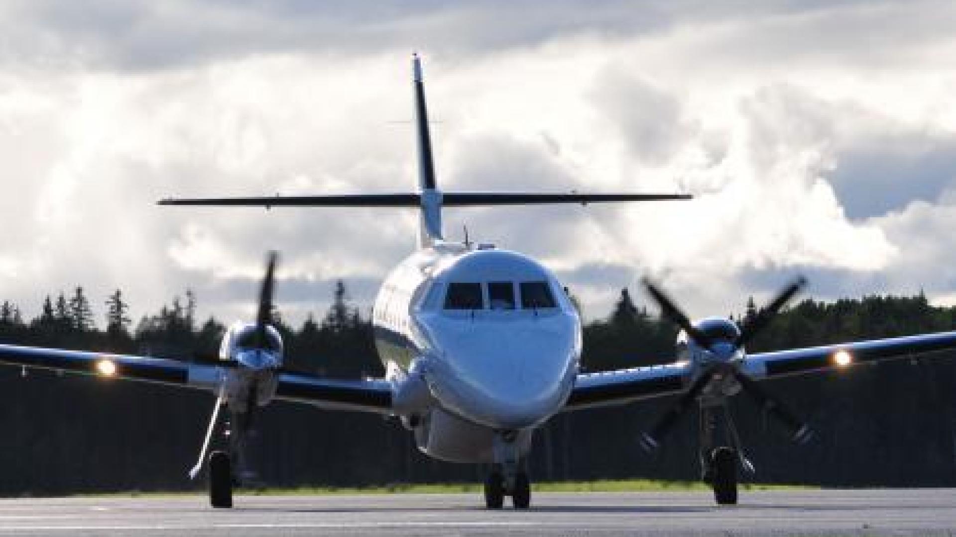 Propeller airplane parked on tarmac. 