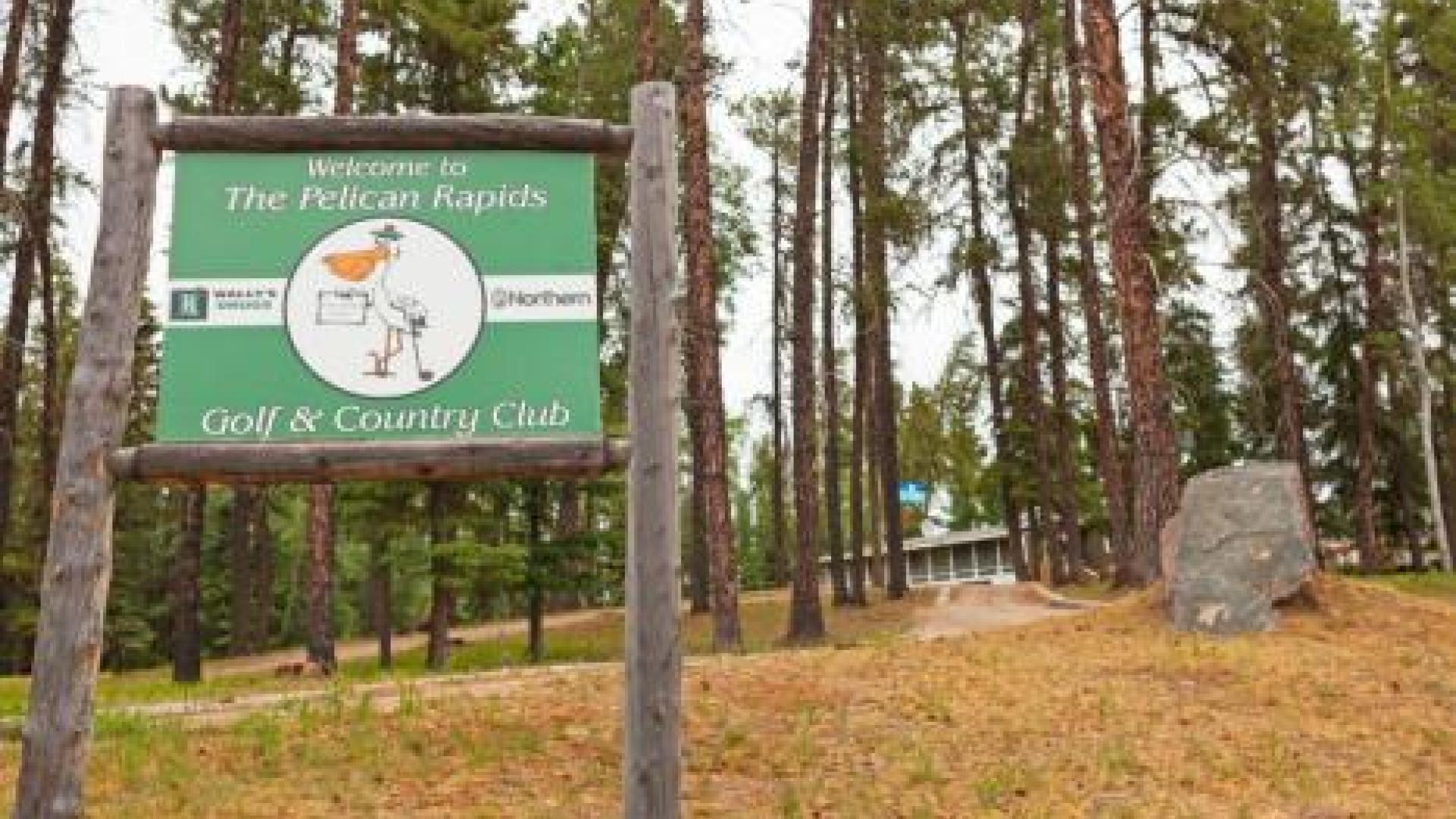 Sign for Pelican Rapids Golf & Country Club. The sign is green and has the logo for the golf and country club on it.