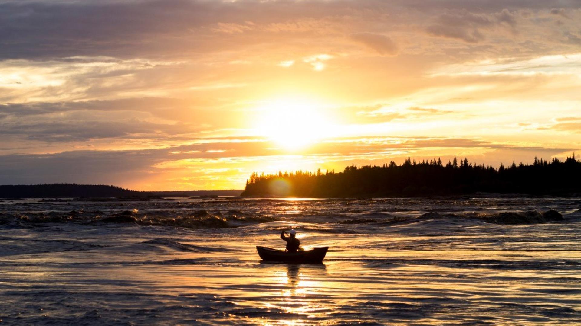 A person in a boat on the water