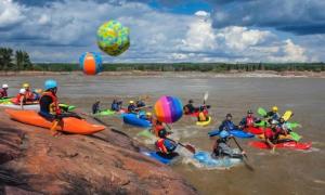 A group of people in kayaks entering the water