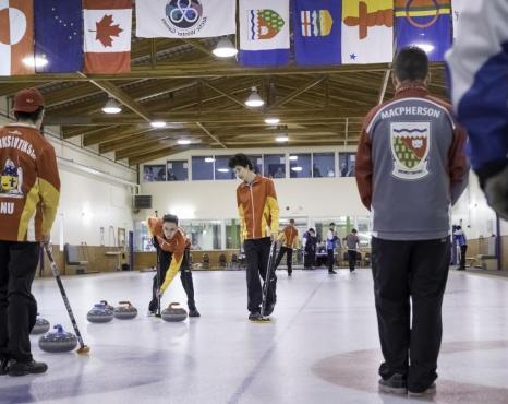 Curling players on curling rink.